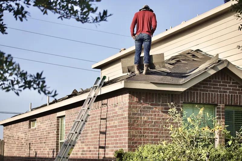 Professional roofer working on a residential roof in Jacobs Lake Shores